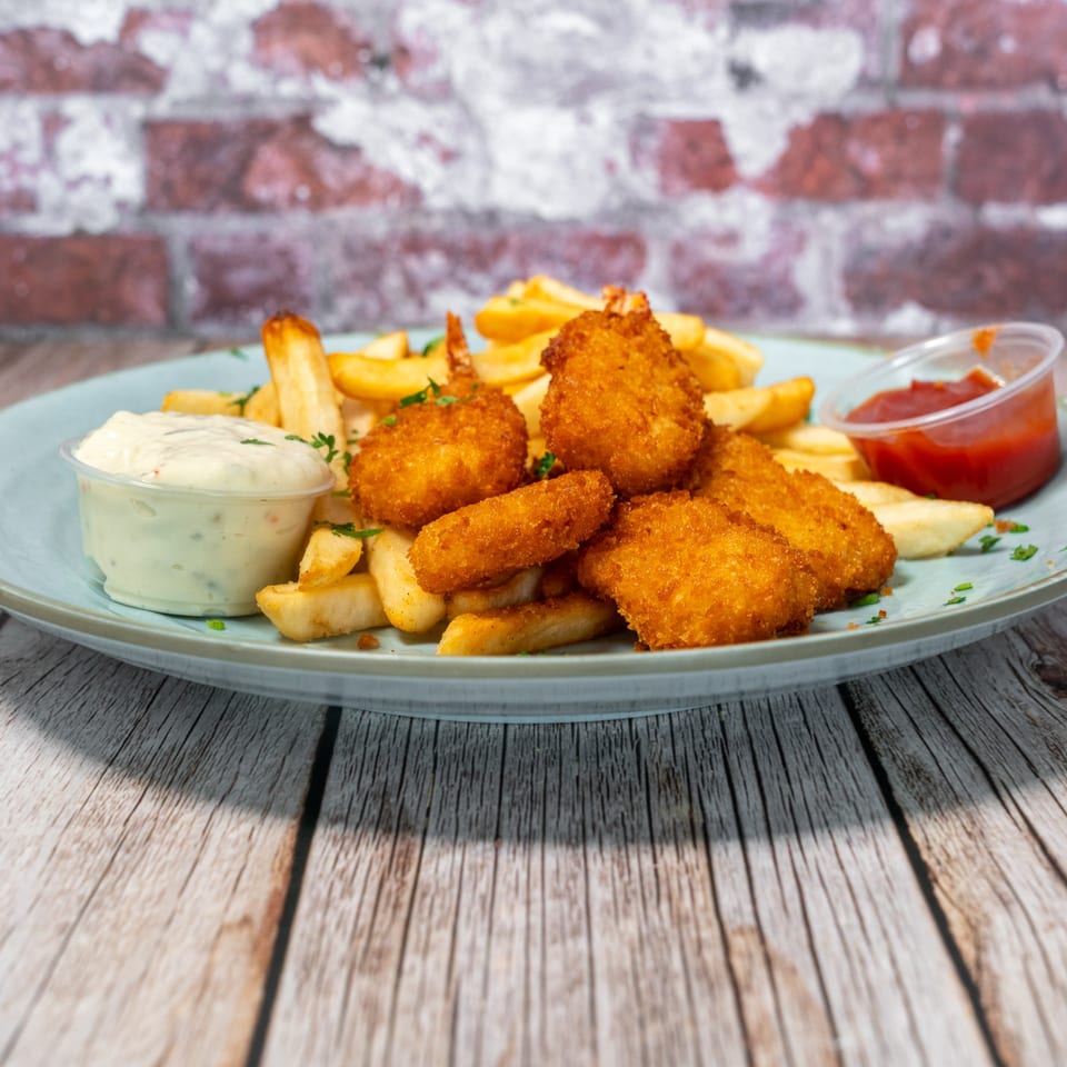 Crispy fried shrimp and golden french fries with tartar sauce and ketchup on a blue plate.